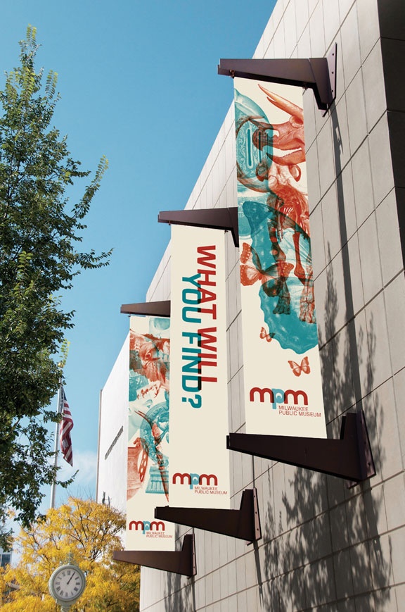 three banners hanging from the side of a building