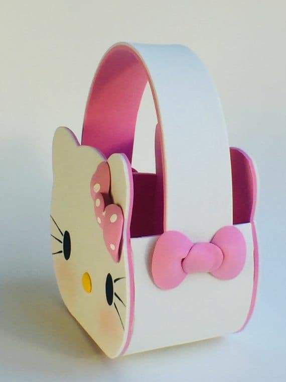 a hello kitty purse with a pink bow on the front and white interior, sitting on a table