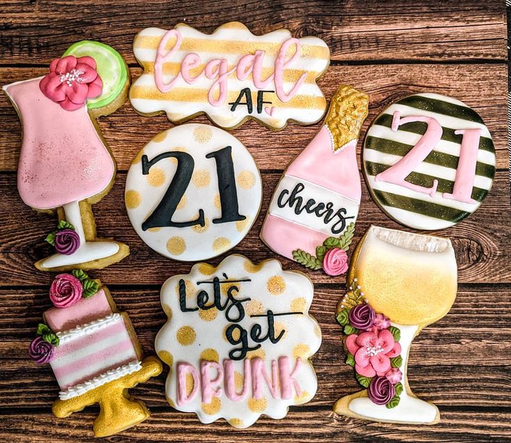 decorated cookies with the number twenty one and two for 21st birthday on a wooden table