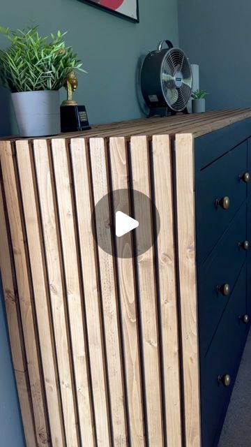 a wooden cabinet sitting on top of a blue dresser