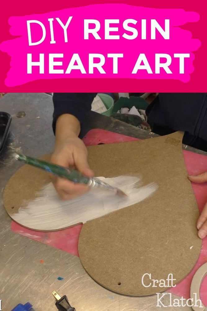 a person is using a brush to paint the paper on a piece of cardboard with text overlay that reads diy resin heart art