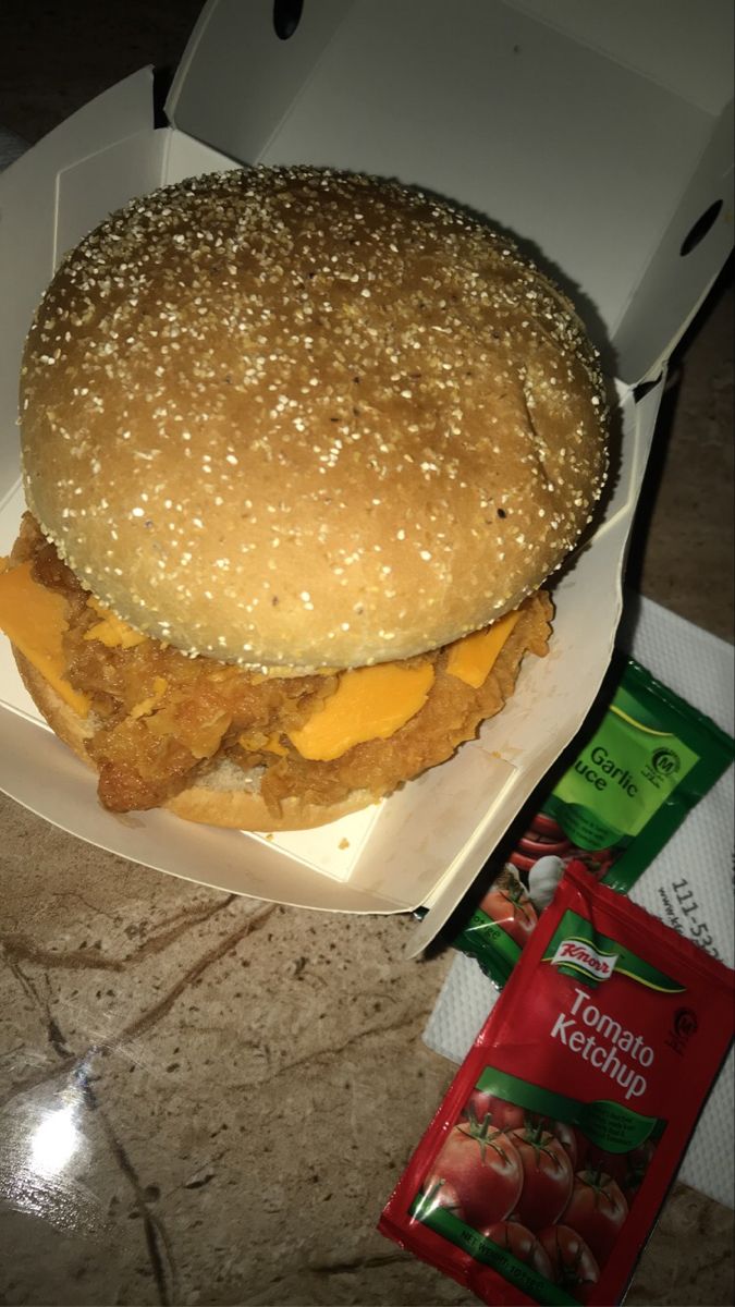 a chicken sandwich in a box on a table