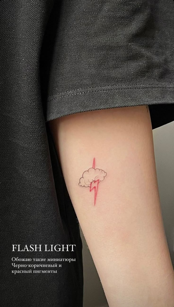 a woman's arm with a lightning bolt tattoo on the left side of her arm