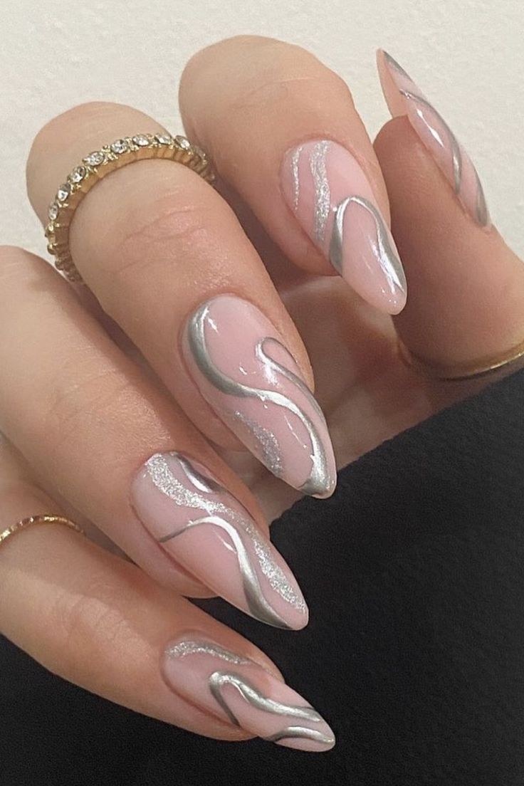 a woman's nails with white and silver designs