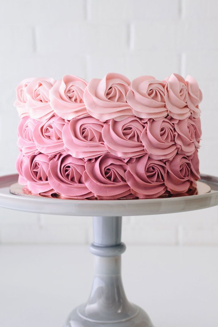 a cake with pink frosting roses on top