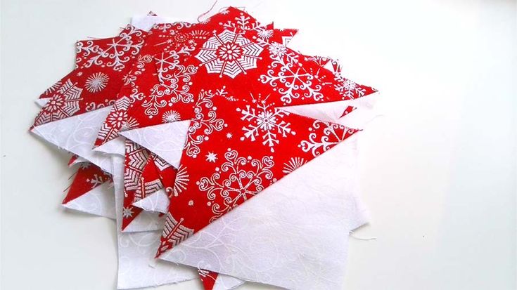 several pieces of red and white fabric with snowflakes on them