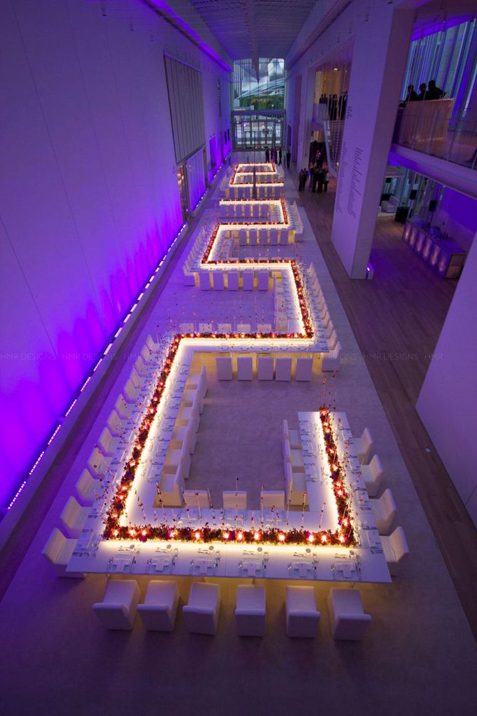 a room filled with tables and chairs covered in lights