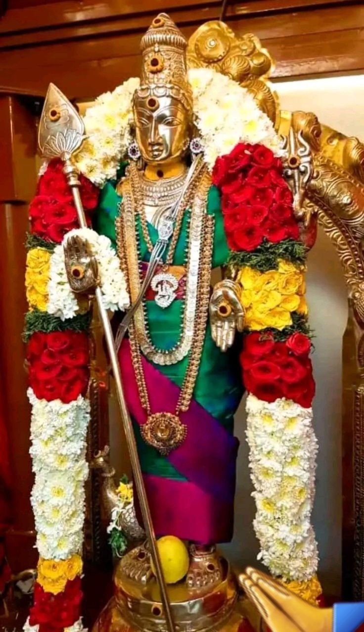 the statue is decorated with flowers and other decorations