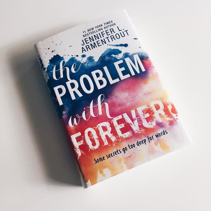 the problem with forever book sitting on top of a white table next to a pen