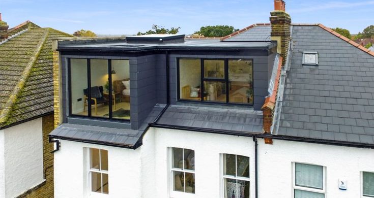 an aerial view of the roof of a house with dormers and windows on each side