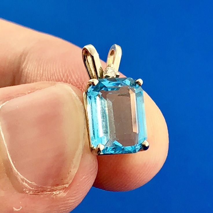 * 14K White Gold Rectangular Swiss Blue Topaz Diamond Accent Pendant * Length: 1/2" including the bale * Width: 3/8" * Swiss Blue Topaz measures: approximately 2.5 tcw * Round Accent diamond measures: approximately .005 tcw * Weight: 1.1 tgw * Marked: 14K * Chain is not included, but can be purchased at an additional price * Condition: Great * G1377    Exported By ExportYourStore :) Blue Rectangular Topaz Jewelry, Blue Topaz Gemstones With Prong Setting, Blue Topaz Pendant, Topaz Pendant, Swiss Blue Topaz, Blue Topaz, Topaz, Jewelry Necklace Pendant, Etsy Accessories