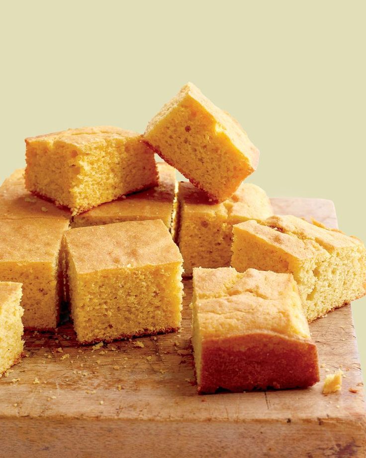 several pieces of cake sitting on top of a cutting board