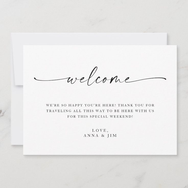 a white card with the words welcome written in cursive writing on it, along with an envelope