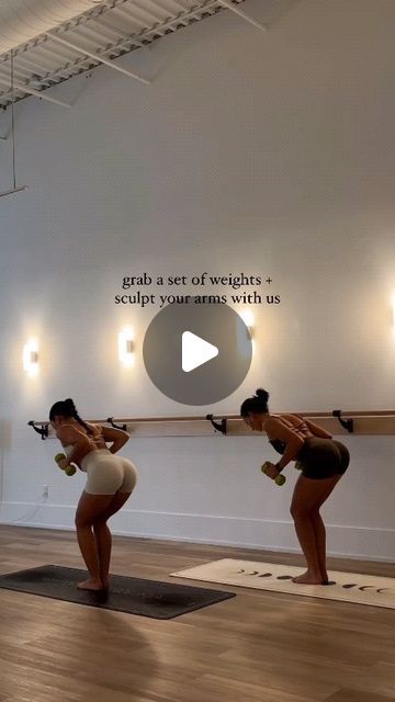 two women doing exercises on yoga mats in front of a white wall with the words grab a set of weights and sculpt your arms with us