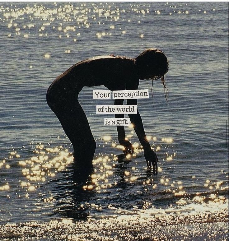 a woman bending over in the water holding a sign that reads your percection of the world is ent