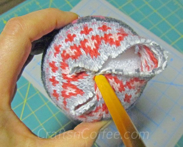 someone is cutting fabric with a pair of scissors to cut it into small pieces that are red and white