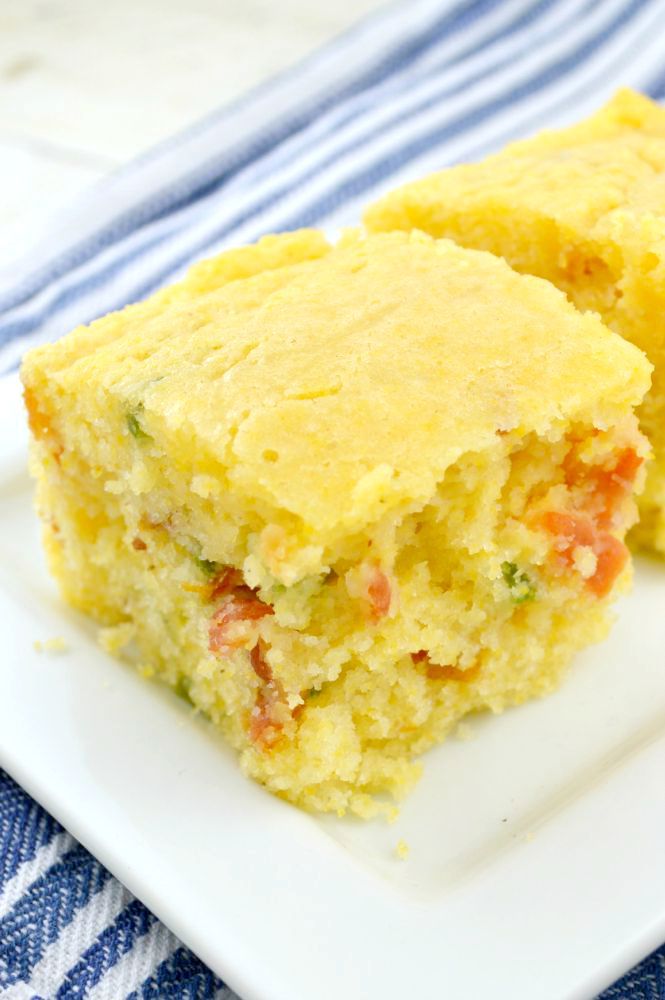 two pieces of cornbread on a white plate