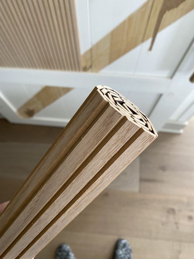 someone is standing on the floor with their feet propped up and looking down at some wood planks