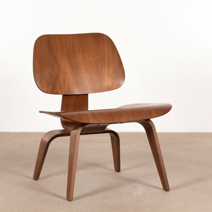 an eames chair with a wooden seat and back rest