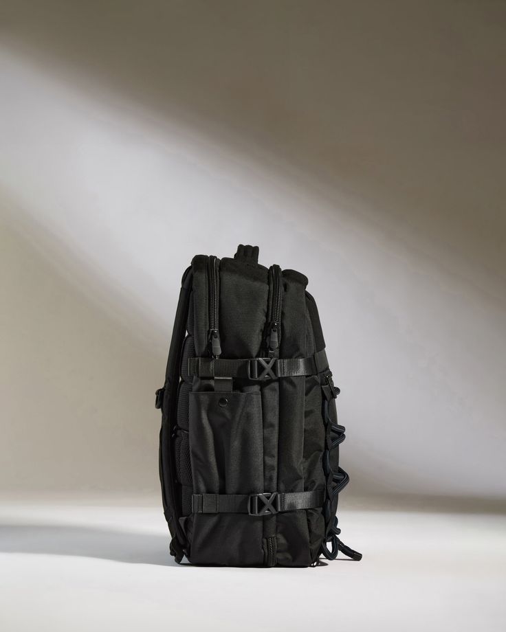 Make a seamless transition from weekdays to weekends with our Discovery Backpack. Offering a generous 28L packing capacity for work, play and every journey in between, the streamlined back-sleeve slots over your suitcase handle for hands-free carrying. Crafted from fully recycled polyester, this lightweight and durable travel companion features twisted ripstop reinforcement, ensuring it withstands the rigors of daily travel and water-resistant protection for peace of mind in wet weather. Designe Large Capacity Nylon Backpack For Trip, Nylon Laptop Bag For Trip, Rectangular, Rectangular Nylon Laptop Bag For Trip, Black Standard Backpack For Overnight Trips, Black Backpack For Overnight Trips, Black Travel Bag For Overnight Trips, Black Practical Standard Backpack Luggage, Practical Black Standard Backpack Luggage, Functional Large Capacity Standard Backpack Luggage