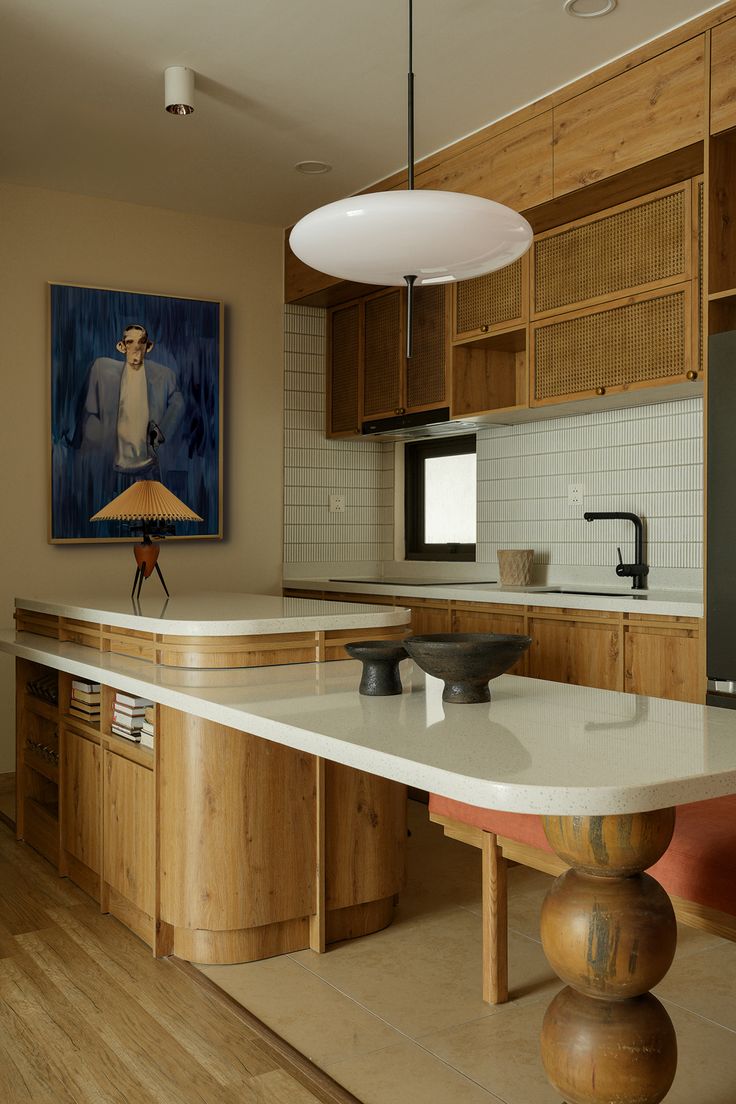 a large kitchen with wooden cabinets and white counter tops, an island in the middle