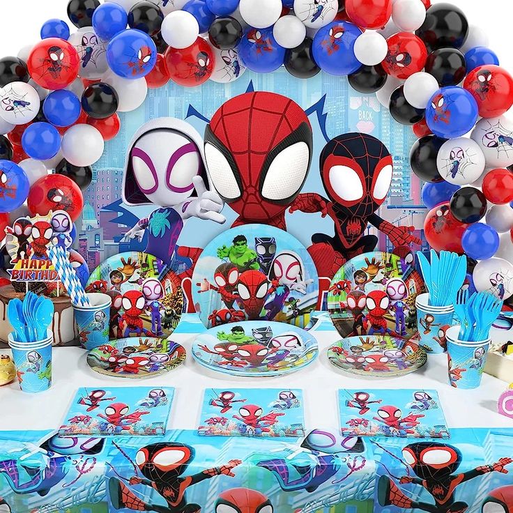 a spiderman themed birthday party with balloons and tableware set up on a table