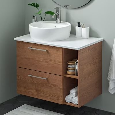 a bathroom with a sink, mirror and towel on the rack next to the wall