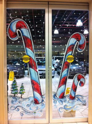 two glass doors with candy canes painted on them