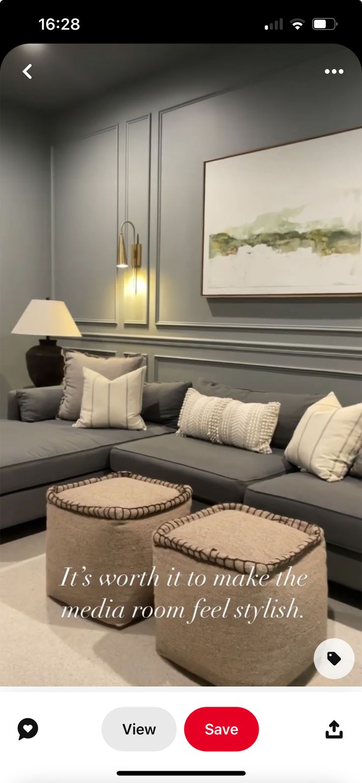 a living room with grey couches and pillows