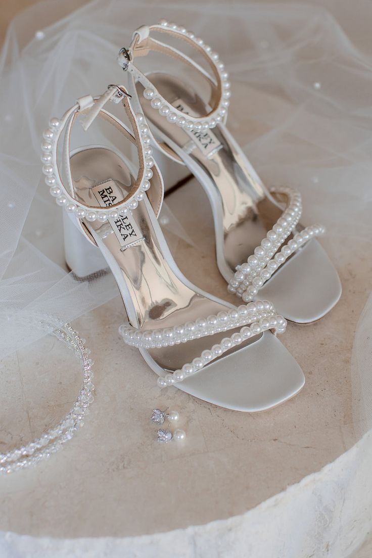 the bride's wedding shoes and bracelet are on display