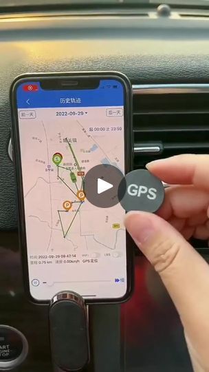 a person is holding a gps device in their hand and pressing the button on it