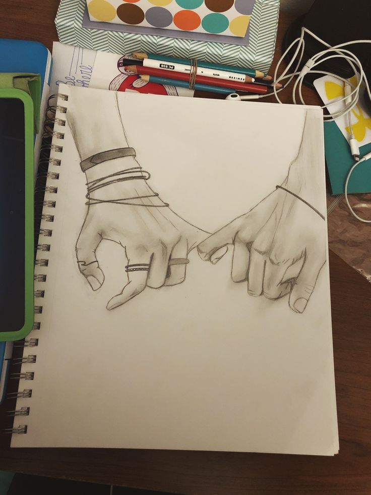 a drawing of two hands holding each other's hand on top of a table