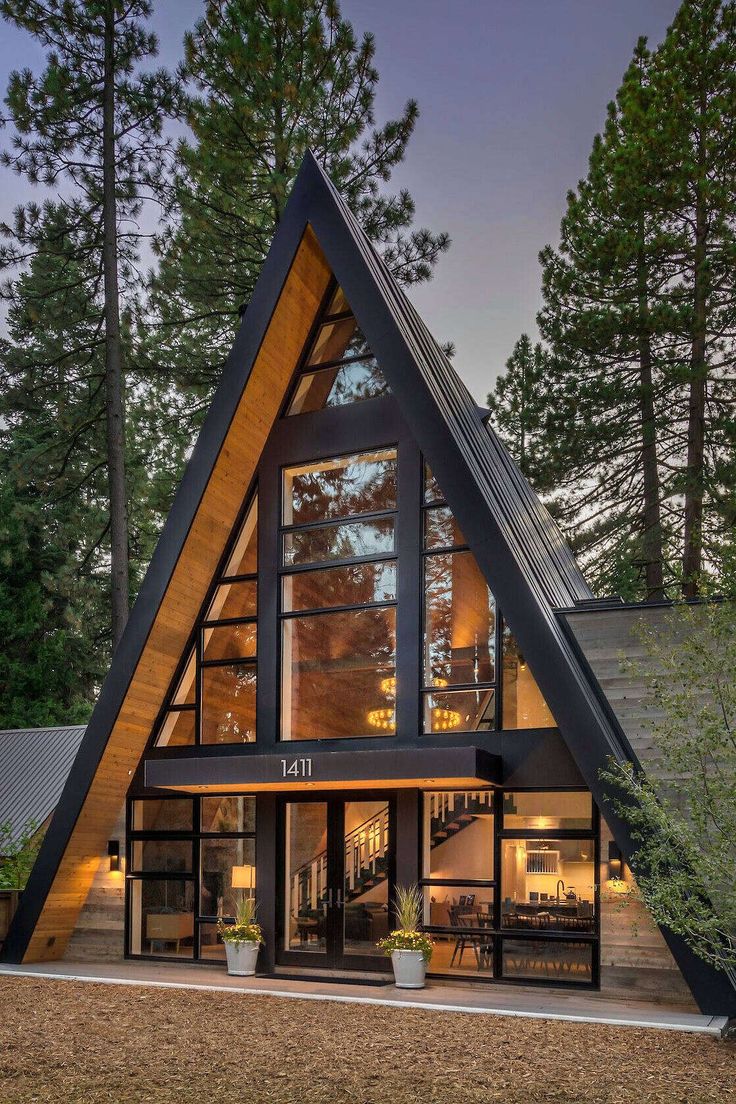 a - frame house in the woods at night