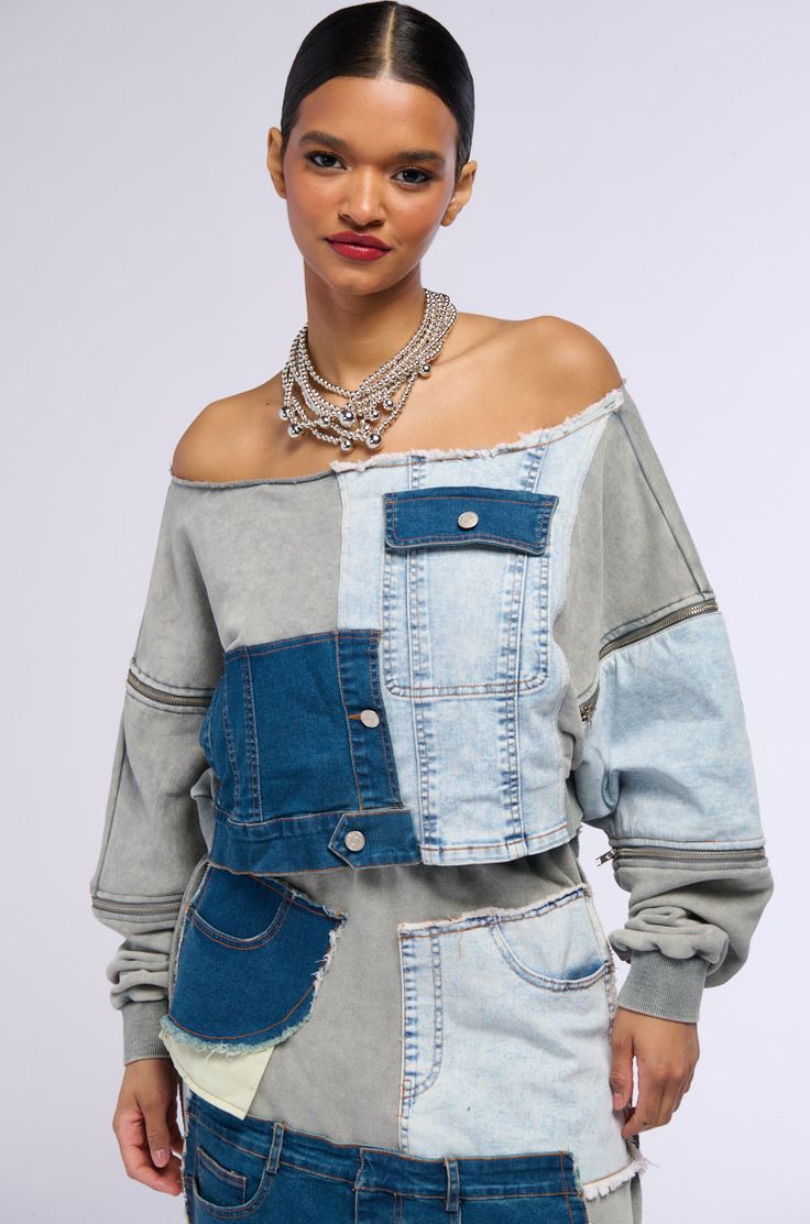 This denim moment lives in our minds rent free. The AKIRA Label Denim Dreams Zipper Detail Sweatshirt is made from a cotton blend base that consists of denim and knit patchwork fabrications. This trendy piece features an off the shoulder design, long sleeves with zipper accents and ribbed knit cuffs, and a cropped, boxy fit. Complete with faux button accents, a mock flap pocket, and a pull-on fit. Finish off the fit with the coordinating bottoms, The AKIRA Label Denim Dreams Maxi Skirt.  - Main: 65% Cotton 35% Polyester, Trim: 75% Cotton 23% Polyester 2% Spandex - Hand Wash Cold - Super Stretchy - Imported (all measurements are approximate from size small) - 16” Shoulder to Hem - 21” Sleeves - Model is 5'10" Product ID: 363014 (all measurements are approximate from size 1X) - 19” Shoulder Denim Blue Patchwork Denim Top, Medium Wash Denim Patchwork Top, Denim Blue Patchwork Top For Fall, Fall Denim Blue Patchwork Denim Top, Casual Patchwork Denim Top For Fall, Fall Denim Blue Patchwork Top, Trendy Denim Blue Patchwork Top, Casual Denim Blue Patchwork Top, Trendy Denim Patchwork Tops