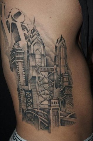 a man's stomach with a city tattoo on it