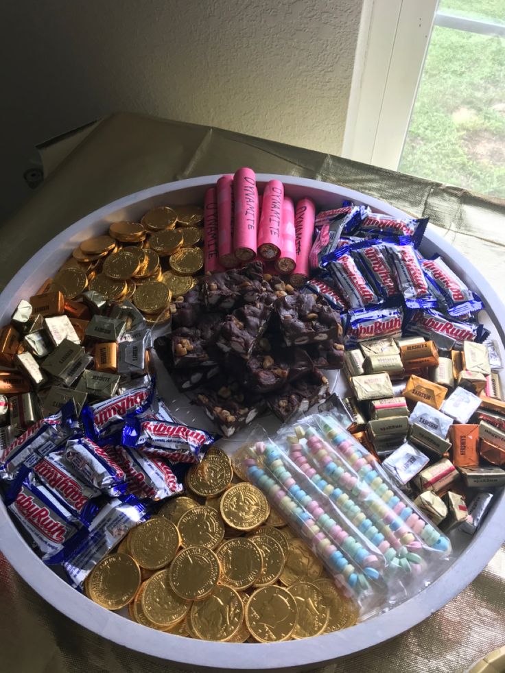 a white tray filled with candy and coins