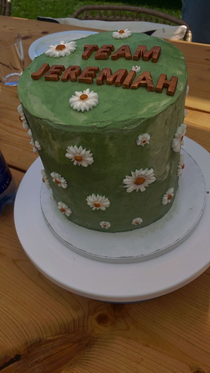 a green cake sitting on top of a white plate