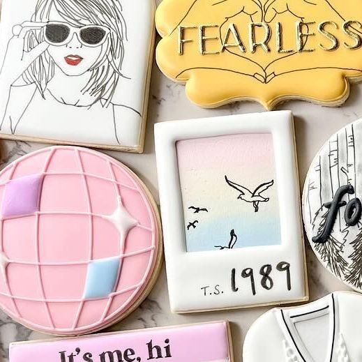 decorated cookies are arranged on a table with the words fearless, it's me, hi