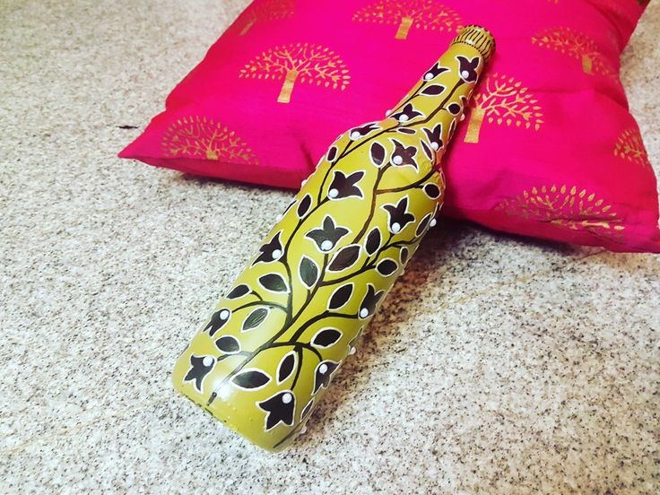 two pillows and a decorative vase on the floor in front of a pink pillow cover