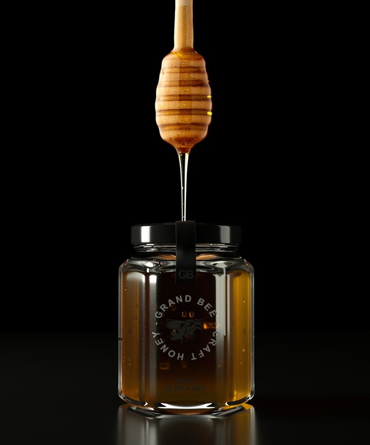 a honey jar with a wooden stick sticking out of it