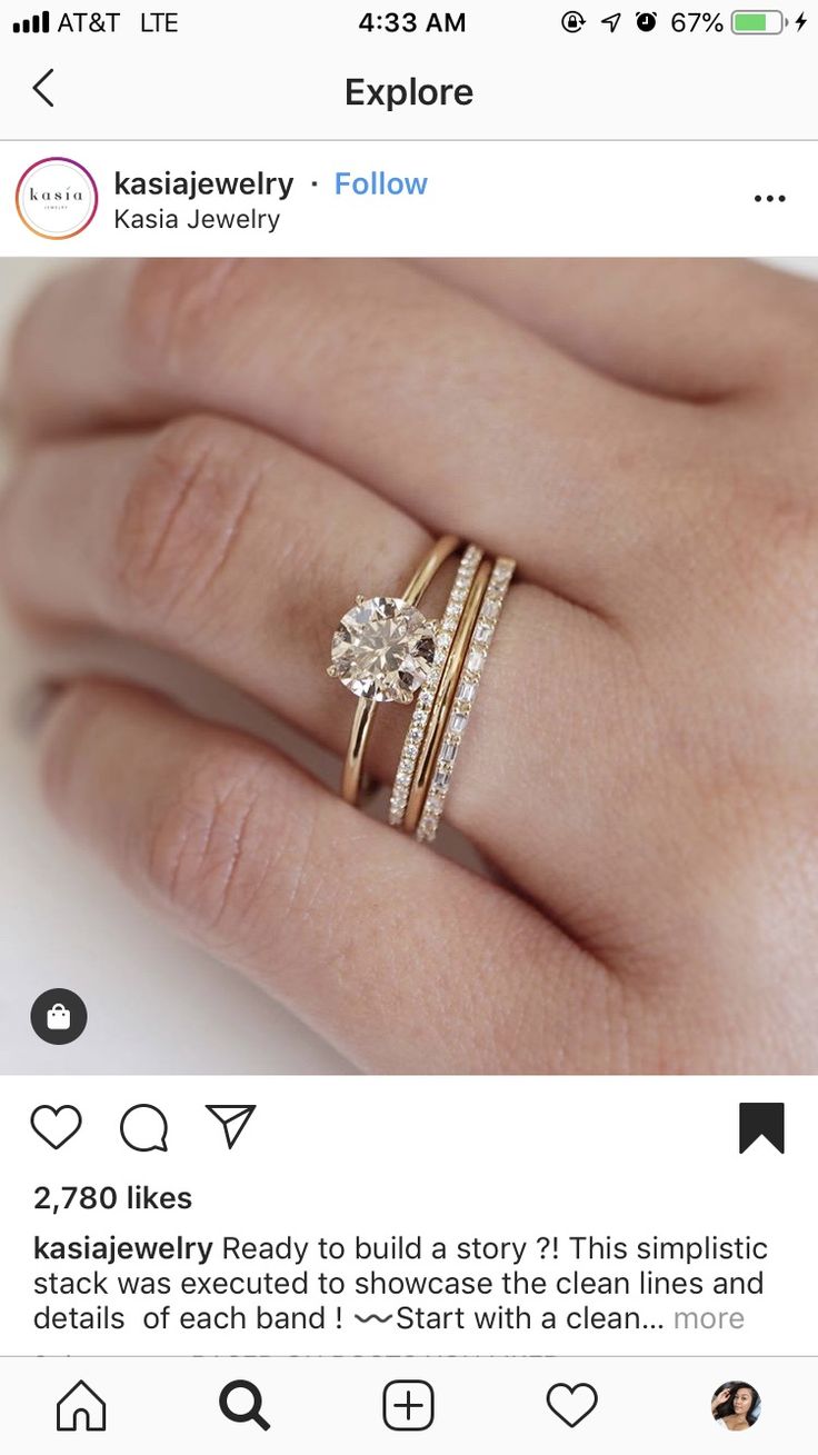 a woman's hand with two rings on it and the ring has an oval shaped diamond