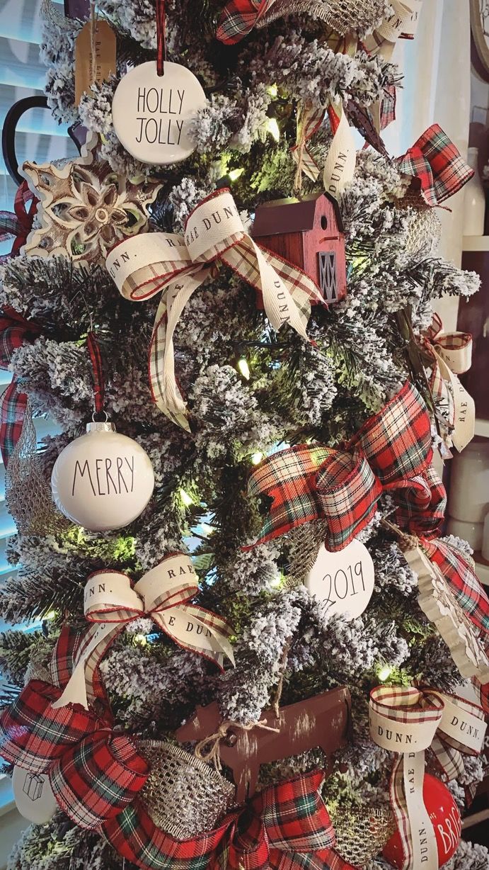 a christmas tree decorated with plaid ribbon and ornaments