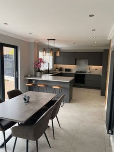 a kitchen and dining room with sliding glass doors that open onto the outside patio area