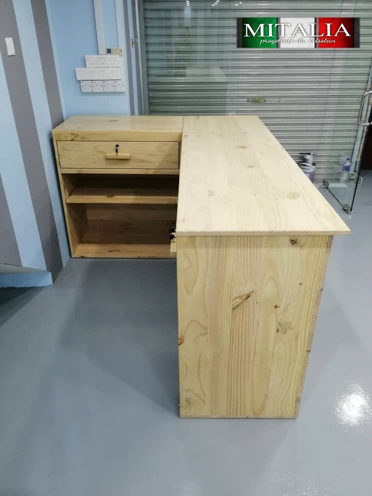 a wooden desk sitting inside of a garage