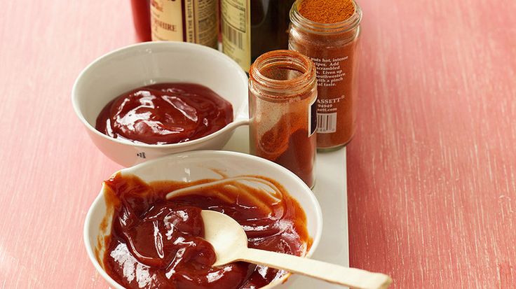 two bowls filled with sauce sitting on top of a table next to condiments