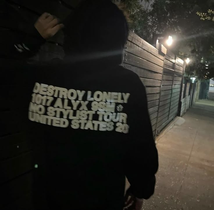 the back of a person wearing a hoodie that reads destroy lonely but ally one is not stylist tour united states 2