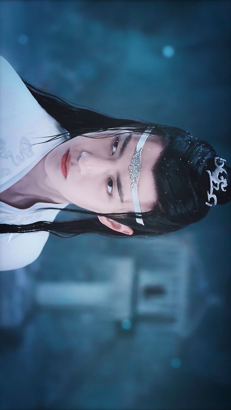 a woman with long black hair wearing a white shirt and silver jewelry on her head