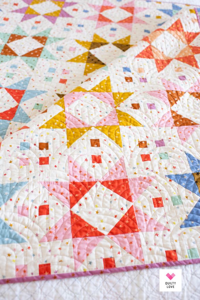 a colorful quilt with stars on it