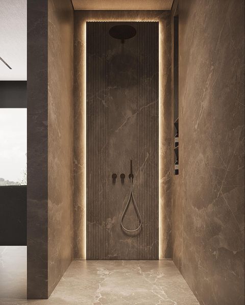 a bathroom with marble walls and flooring has a shower in the middle, illuminated by recessed lighting