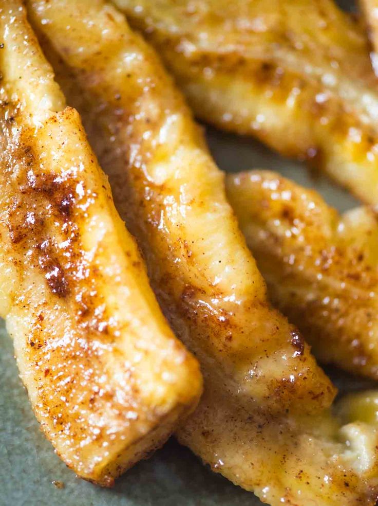 some bananas are sitting on a plate and ready to be grilled or cooked in the oven